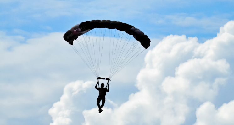 Parachuting with blue sky and white, fluffy clouds